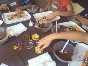 girls making chocolate lollipops